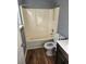 Bathroom featuring shower-tub combo and vinyl flooring at 5778 Eagles Feather Ln, Riverdale, GA 30274