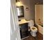 Bathroom featuring shower-tub combo, wood-look floor, and modern vanity at 5778 Eagles Feather Ln, Riverdale, GA 30274