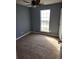 Bedroom featuring carpeting, fan, and a window providing natural light at 5778 Eagles Feather Ln, Riverdale, GA 30274