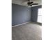 Bedroom featuring neutral color palette, fan, carpeting, and a window at 5778 Eagles Feather Ln, Riverdale, GA 30274