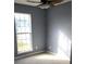 This is a cozy bedroom with a window, fan and neutral color palette at 5778 Eagles Feather Ln, Riverdale, GA 30274