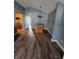 Dining area with modern lighting fixture and wood-look flooring at 5778 Eagles Feather Ln, Riverdale, GA 30274