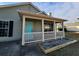 Covered front porch with white railing and stone landscaping at 5778 Eagles Feather Ln, Riverdale, GA 30274