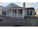 Charming single-story home featuring a covered front porch and manicured lawn at 5778 Eagles Feather Ln, Riverdale, GA 30274