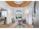 Elegant foyer with a wood ceiling, stone floors, and a rustic table with floral decor at 7455 Old Rico Rd, Chattahoochee Hills, GA 30268