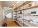 Hallway with staircase and custom shelving providing storage at 7455 Old Rico Rd, Chattahoochee Hills, GA 30268