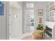 Hallway with white walls, colorful decor, and built-in shelving to the right of an inviting floral chair at 7455 Old Rico Rd, Chattahoochee Hills, GA 30268