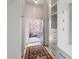 Hallway with wood floors, built-in shelving and cabinets leading to an outdoor courtyard at 7455 Old Rico Rd, Chattahoochee Hills, GA 30268
