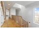 Hallway featuring wooden railings, skylight, and natural light at 7455 Old Rico Rd, Chattahoochee Hills, GA 30268