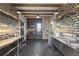 Modern kitchen with stainless steel counters, open shelving, and geometric tile accent wall at 7455 Old Rico Rd, Chattahoochee Hills, GA 30268