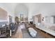 Spacious living room boasts high ceilings, fireplace, and open layout to the kitchen and dining areas at 7455 Old Rico Rd, Chattahoochee Hills, GA 30268