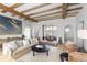 Bright and spacious living room with beamed ceilings, stone floors, and decor at 7455 Old Rico Rd, Chattahoochee Hills, GA 30268