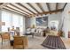 Inviting living room with beamed ceilings, stone floors, and stylish decor at 7455 Old Rico Rd, Chattahoochee Hills, GA 30268