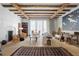 Inviting living room with beamed ceilings, stone floors, and stylish decor at 7455 Old Rico Rd, Chattahoochee Hills, GA 30268