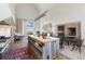 Spacious living and kitchen area with an island, fireplace, and tall ceilings at 7455 Old Rico Rd, Chattahoochee Hills, GA 30268