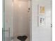 Walk-in shower with white tiled walls, modern fixtures, and an decorative inset floor tile at 7455 Old Rico Rd, Chattahoochee Hills, GA 30268