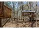 Whimsical treehouses connected by suspended bridge create an enchanting forest adventure at 7455 Old Rico Rd, Chattahoochee Hills, GA 30268