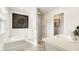 Bright bathroom featuring a tub, shower, and double sink vanity with modern fixtures and decor at 121 Oakchase Park Lane, Hampton, GA 30228