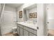 Well-lit bathroom featuring a double sink vanity and a shower-tub combo at 121 Oakchase Park Lane, Hampton, GA 30228