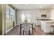 Bright dining area with table, white kitchen, stainless appliances, and a view of the backyard at 121 Oakchase Park Lane, Hampton, GA 30228