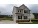 Two-story home with a gray exterior, black shutters, well-maintained lawn, and a driveway at 121 Oakchase Park Lane, Hampton, GA 30228