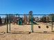 Community playground with swings, slides, and climbing structures, fenced for safety at 121 Oakchase Park Lane, Hampton, GA 30228