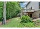 Backyard view with deck, patio, and walkout basement nestled amongst mature trees provides a private and tranquil retreat at 3305 Suffolk Dr, Cumming, GA 30041