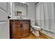 Bathroom featuring modern vanity with a dark wood finish, mirror, toilet, and shower curtain at 3305 Suffolk Dr, Cumming, GA 30041