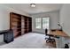 Bedroom with built-in bookshelves, desk and neutral carpeting and paint at 3305 Suffolk Dr, Cumming, GA 30041