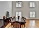 Open dining room features hardwood floors, expansive windows, and stylish black wood dining set at 3305 Suffolk Dr, Cumming, GA 30041