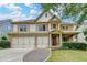 Beautiful two-story home with a brick and siding exterior, three-car garage, and well-manicured front lawn at 3305 Suffolk Dr, Cumming, GA 30041