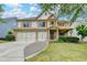 Charming two-story home featuring brick accents, a three-car garage, and a beautifully landscaped front yard at 3305 Suffolk Dr, Cumming, GA 30041