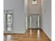 Bright foyer with hardwood floors, a soaring ceiling, and a view of the front door at 3305 Suffolk Dr, Cumming, GA 30041