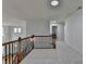 Second floor hallway with dark railings and carpeted floors at 3305 Suffolk Dr, Cumming, GA 30041
