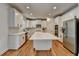 Bright, modern kitchen with white cabinets, stainless steel appliances and large island at 3305 Suffolk Dr, Cumming, GA 30041