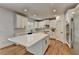 New, all-white kitchen featuring a center island, white stone countertops and stainless steel appliances at 3305 Suffolk Dr, Cumming, GA 30041