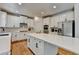 Contemporary kitchen with white cabinets, stainless steel appliances and center island at 3305 Suffolk Dr, Cumming, GA 30041