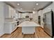 Bright kitchen features a large island with ample counter space, all-white cabinets, and stainless appliances at 3305 Suffolk Dr, Cumming, GA 30041