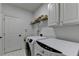 Convenient laundry room features a washer, dryer, and upper cabinets at 3305 Suffolk Dr, Cumming, GA 30041