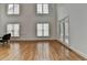 Spacious living room with gleaming hardwood floors, high ceilings, and large windows at 3305 Suffolk Dr, Cumming, GA 30041