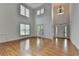 Bright living room with soaring ceilings, large windows, and hardwood flooring presents an airy ambiance at 3305 Suffolk Dr, Cumming, GA 30041