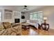 Bright living room features hardwood floors, fireplace with built-ins, and large windows offering natural light at 3305 Suffolk Dr, Cumming, GA 30041