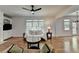Bright living room with hardwood floors, a ceiling fan, and large windows that let in natural light at 3305 Suffolk Dr, Cumming, GA 30041