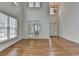 Sun-drenched living room with soaring ceilings and large windows showcases beautiful hardwood flooring at 3305 Suffolk Dr, Cumming, GA 30041