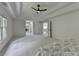 Spacious main bedroom with tray ceiling, fan, and neutral carpeting and paint at 3305 Suffolk Dr, Cumming, GA 30041