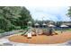 Community playground with colorful structures, slides, and swings nestled amongst mature trees ensures hours of Gathering fun at 3305 Suffolk Dr, Cumming, GA 30041