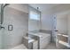 Bright bathroom featuring a shower and soaking tub with gray tiling and black hardware at 3941 Adler Cir, Buford, GA 30519