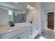 Bathroom featuring dual sinks, a large mirror, tiled floors, and black fixtures at 3941 Adler Cir, Buford, GA 30519