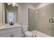 Modern bathroom featuring a tiled shower with glass door, contemporary vanity, and fixtures at 3941 Adler Cir, Buford, GA 30519