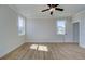 Well-lit bedroom has wood floors, two windows, white trim, and a ceiling fan at 3941 Adler Cir, Buford, GA 30519